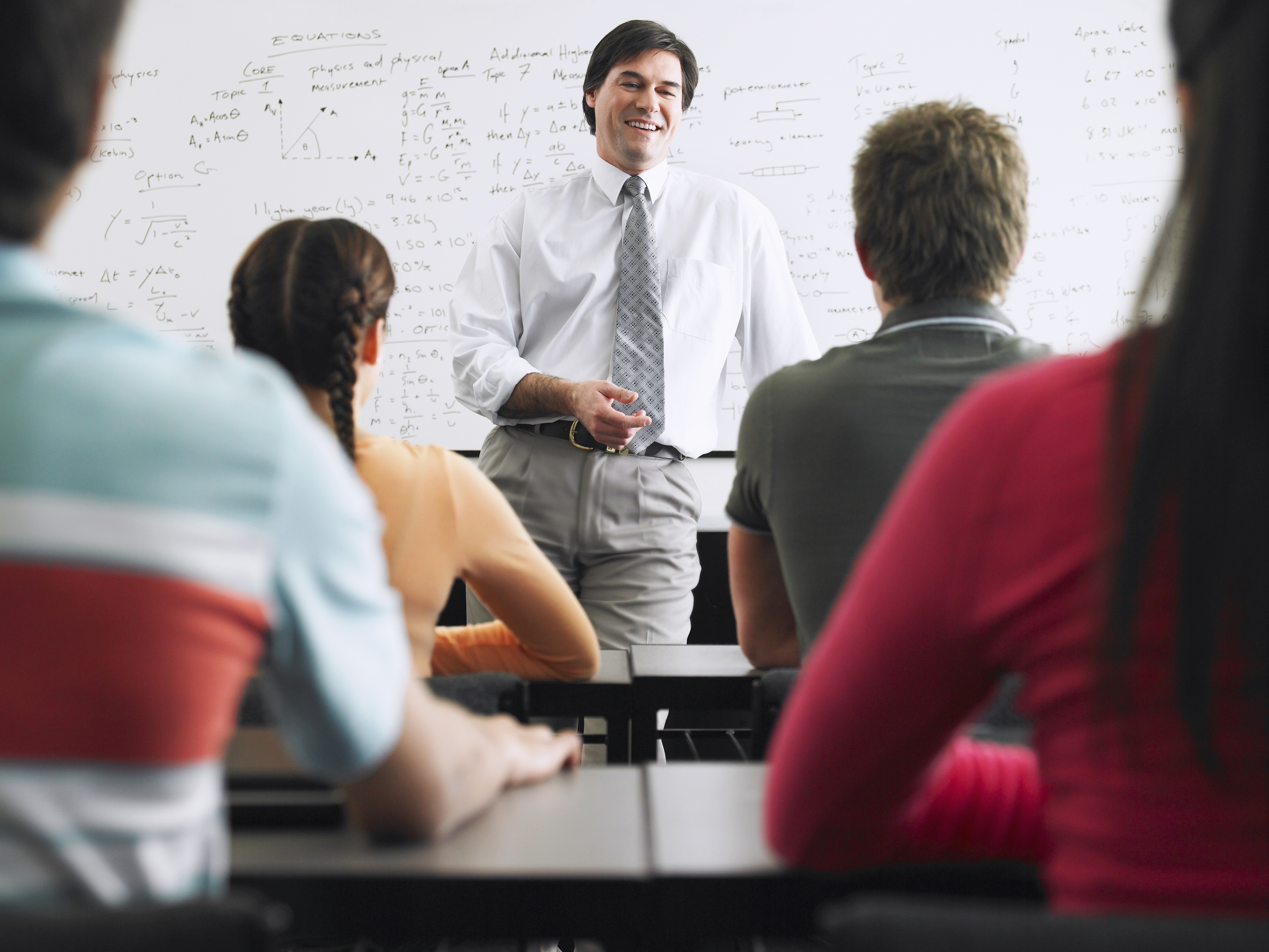 Teacher with a group of high school students in classroom